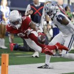 Arizona Cardinals wide receiver Greg Dortch (83) comes up short as he reaches for the goal line as Dallas Cowboys cornerback Trevon Diggs (7) defends during the first half of an NFL football game Sunday, Jan. 2, 2022, in Arlington, Texas. (AP Photo/Michael Ainsworth)
