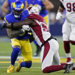 Los Angeles Rams wide receiver Odell Beckham Jr., left, is tackled by Arizona Cardinals outside linebacker Chandler Jones during the first half of an NFL wild-card playoff football game in Inglewood, Calif., Monday, Jan. 17, 2022. (AP Photo/Marcio Jose Sanchez)