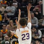 Phoenix Suns forward Cameron Johnson (23) shoots as Utah Jazz forward Bojan Bogdanovic (44) defends in the first half during an NBA basketball game Wednesday, Jan. 26, 2022, in Salt Lake City. (AP Photo/Rick Bowmer)