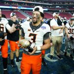 Oklahoma State quarterback Spencer Sanders (3) celebrates after the Fiesta Bowl NCAA college football game against Notre Dame, Saturday, Jan. 1, 2022, in Glendale, Ariz. Oklahoma State won 37-35. (AP Photo/Ross D. Franklin)