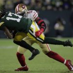 San Francisco 49ers' Azeez Al-Shaair stops Green Bay Packers' Davante Adams during the first half of an NFC divisional playoff NFL football game Saturday, Jan. 22, 2022, in Green Bay, Wis. (AP Photo/Aaron Gash)