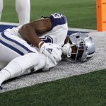 Dallas Cowboys wide receiver Michael Gallup holds his leg after being injured while catching a touchdown pass against the Arizona Cardinals during the first half of an NFL football game Sunday, Jan. 2, 2022, in Arlington, Texas. (AP Photo/Roger Steinman)