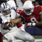 Arizona Cardinals inside linebacker Isaiah Simmons (9) forces a fumble by Dallas Cowboys quarterback Dak Prescott (4) during the second half of an NFL football game Sunday, Jan. 2, 2022, in Arlington, Texas. The Cardinals recovered the fumble. (AP Photo/Roger Steinman)