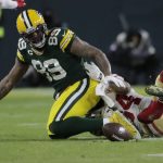 Green Bay Packers' Marcedes Lewis fumbles as he is hit by San Francisco 49ers' Fred Warner during the first half of an NFC divisional playoff NFL football game Saturday, Jan. 22, 2022, in Green Bay, Wis. (AP Photo/Aaron Gash)