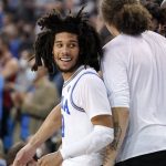 UCLA guard Tyger Campbell, left, celebrates with teammate after being taken out of the game in the closing second of the second half of an NCAA college basketball game against Arizona Tuesday, Jan. 25, 2022, in Los Angeles. (AP Photo/Mark J. Terrill)
