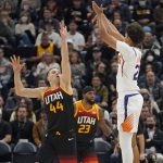 Phoenix Suns forward Cameron Johnson, right, shoots over Utah Jazz forward Bojan Bogdanovic (44) in the first half during an NBA basketball game Wednesday, Jan. 26, 2022, in Salt Lake City. (AP Photo/Rick Bowmer)