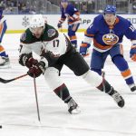Arizona Coyotes center Alex Galchenyuk (17) skates in front of New York Islanders left wing Zach Parise (11) during the second period of an NHL hockey game Friday, Jan. 21, 2022, in Elmont, N.Y. (AP Photo/Corey Sipkin).