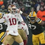 San Francisco 49ers' Jimmy Garoppolo thorws with Green Bay Packers' Kenny Clark rushing during the second half of an NFC divisional playoff NFL football game Saturday, Jan. 22, 2022, in Green Bay, Wis. (AP Photo/Morry Gash)