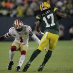 Green Bay Packers' Davante Adams tries to get past San Francisco 49ers' Jimmie Ward during the first half of an NFC divisional playoff NFL football game Saturday, Jan. 22, 2022, in Green Bay, Wis. (AP Photo/Aaron Gash)