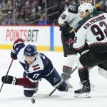 Colorado Avalanche center Tyson Jost (17) fights for the puck with Arizona Coyotes' Vladislav Kolyachonok (92) during the first period of an NHL hockey game Friday, Jan. 14, 2022, in Denver. (AP Photo/Jack Dempsey)