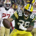 Green Bay Packers' A.J. Dillon (28) reacts after running for a touchdown during the firsrt half of an NFC divisional playoff NFL football game against the San Francisco 49ers Saturday, Jan. 22, 2022, in Green Bay, Wis. (AP Photo/Matt Ludtke)