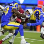 Los Angeles Rams outside linebacker Leonard Floyd, left, tackles Arizona Cardinals running back James Conner during the first half of an NFL wild-card playoff football game in Inglewood, Calif., Monday, Jan. 17, 2022. (AP Photo/Jae C. Hong)