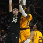 Colorado center Lawson Lovering (34) drives against Arizona State center Enoch Boakye (14) during the first half of an NCAA college basketball game, Saturday, Jan. 15, 2022, in Tempe, Ariz. (AP Photo/Rick Scuteri)
