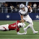 Dallas Cowboys tight end Dalton Schultz (86) is tackled by Arizona Cardinals cornerback Byron Murphy Jr. (7) after catching a pass for a first down during the first half of an NFL football game Sunday, Jan. 2, 2022, in Arlington, Texas. (AP Photo/Ron Jenkins)