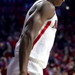 Arizona guard Bennedict Mathurin (0) reacts after his one-handed dunk against Washington during the first half of an NCAA college basketball game in Tucson, Ariz., Monday, Jan. 3, 2022. (Rebecca Sasnett/Arizona Daily Star via AP)