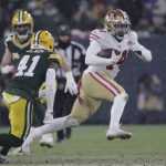 San Francisco 49ers' Kyle Juszczyk runs past Green Bay Packers' Henry Black during the second half of an NFC divisional playoff NFL football game Saturday, Jan. 22, 2022, in Green Bay, Wis. (AP Photo/Aaron Gash)