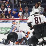 New York Islanders left wing Anthony Beauvillier (18) celebrates a goal by center Brock Nelson during the third period of an NHL hockey game against the Arizona Coyotes, Friday, Jan. 21, 2022, in Elmont, N.Y. (AP Photo/Corey Sipkin).