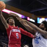Arizona guard Justin Kier, left, shoots as UCLA center Myles Johnson defends during the first half of an NCAA college basketball game Tuesday, Jan. 25, 2022, in Los Angeles. (AP Photo/Mark J. Terrill)
