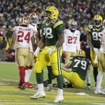 Green Bay Packers' A.J. Dillon (28) reacts after running for a touchdown during the firsrt half of an NFC divisional playoff NFL football game against the San Francisco 49ers Saturday, Jan. 22, 2022, in Green Bay, Wis. (AP Photo/Matt Ludtke)