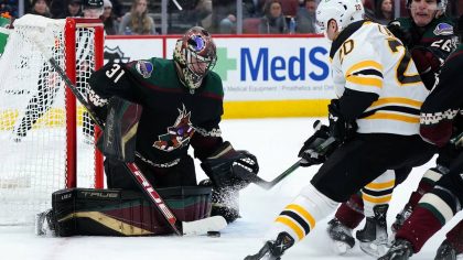 Arizona Coyotes goaltender Scott Wedgewood (31) makes a save on a shot by Boston Bruins center Curt...