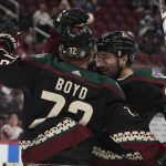 Arizona Coyotes' Nick Schmaltz (8) right, celebrates with Travis Boyd (72) after Boyd's goal against the Montreal Canadiens during the first period of an NHL hockey game Monday, Jan. 17, 2022, in Glendale, Ariz. (AP Photo/Darryl Webb)