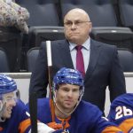 New York Islanders coach Barry Trotz, top, looks on during the first period of an NHL hockey game against the Arizona Coyotes, Friday, Jan. 21, 2022, in Elmont, N.Y. (AP Photo/Corey Sipkin).
