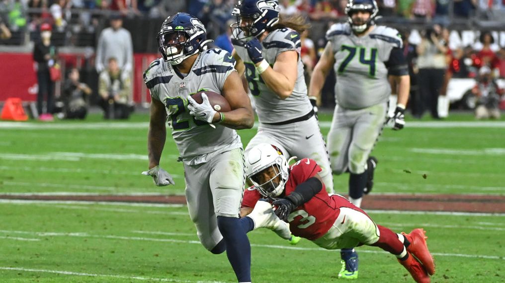 Rashaad Penny #20 of the Seattle Seahawks runs the ball for a touchdown during the fourth quarter a...