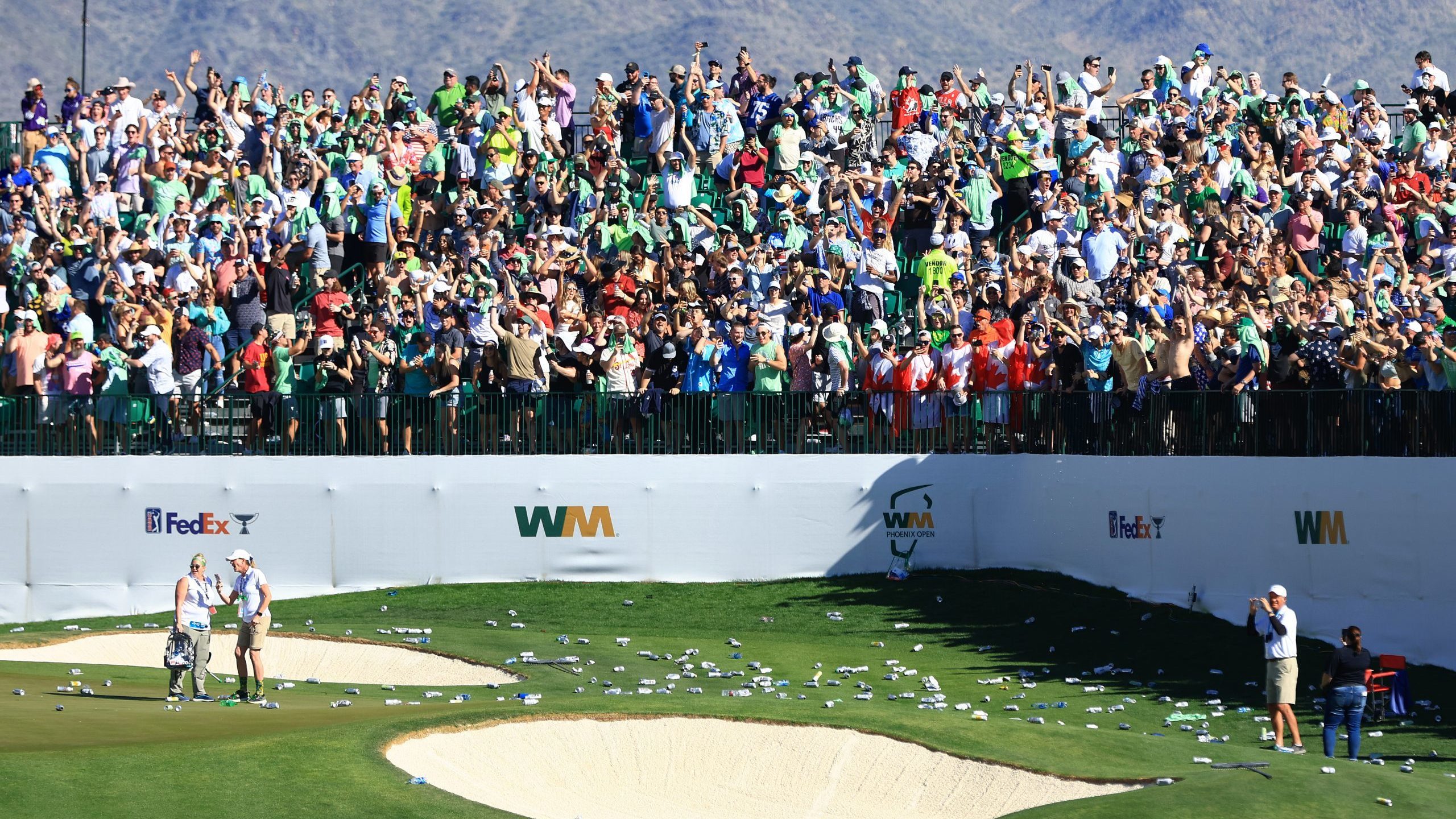 SCOTTSDALE, ARIZONA - FEBRUARY 12: Bottles litter the 16th hole after a hole-in-one by Sam Ryder of...