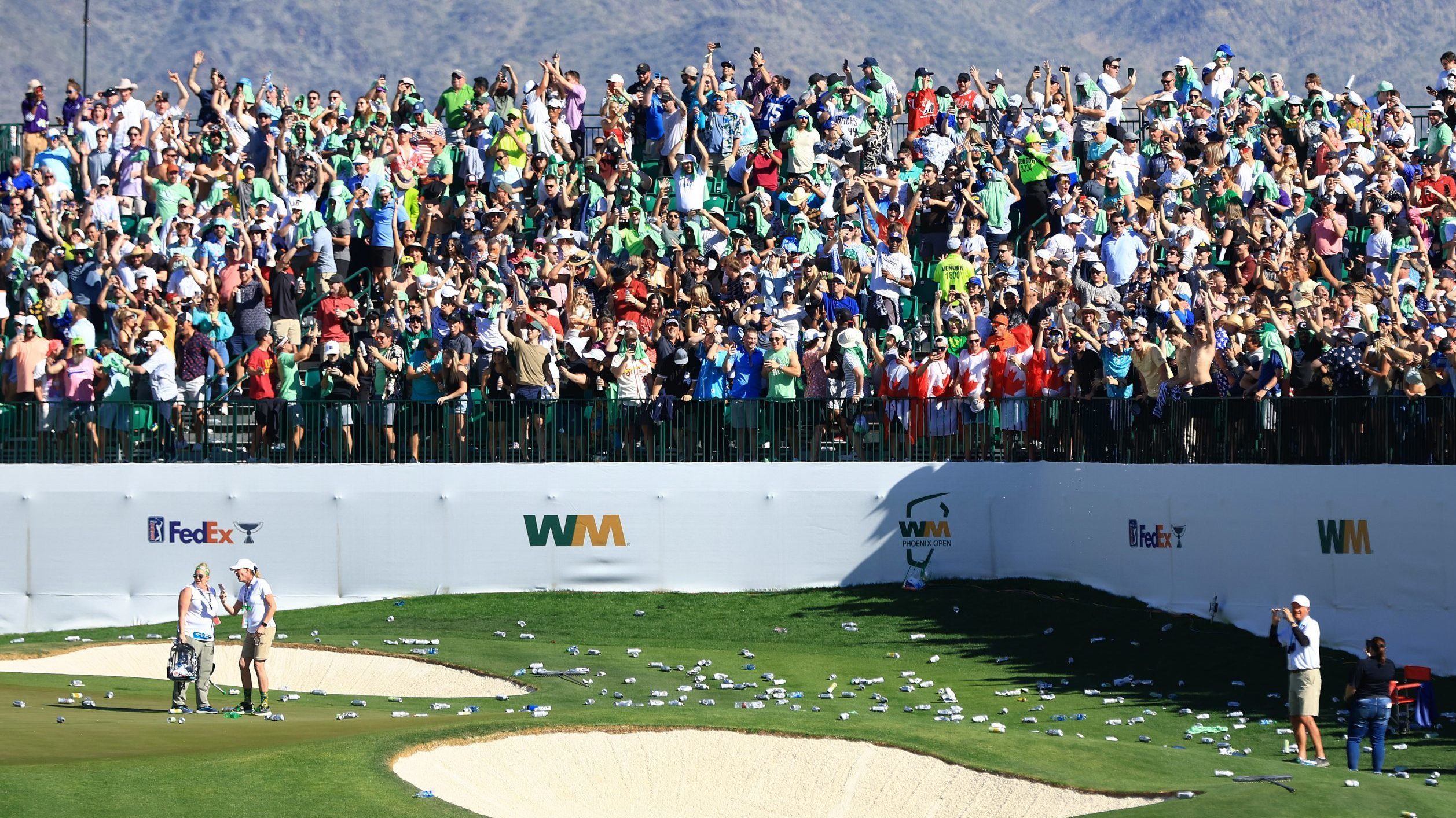 SCOTTSDALE, ARIZONA - FEBRUARY 12: Bottles litter the 16th hole after a hole-in-one by Sam Ryder of...