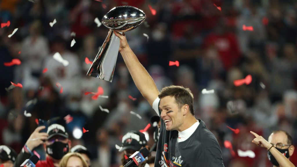 Tom Brady #12 of the Tampa Bay Buccaneers hoists the Vince Lombardi Trophy after winning Super Bowl...