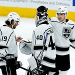Los Angeles Kings goaltender Cal Petersen (40) celebrates the team's win against the Arizona Coyotes with left wing Alex Iafallo (19) and right wing Dustin Brown (23) at the end of an NHL hockey game Wednesday, Feb. 23, 2022, in Glendale, Ariz. The Kings won 3-2. (AP Photo/Ross D. Franklin)