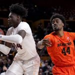 Arizona State center Enoch Boakye (14) rebounds as Oregon State forward Ahmad Rand (44) looks on during the first half of an NCAA college basketball game, Saturday, Feb. 19, 2022, in Tempe, Ariz. (AP Photo/Matt York)