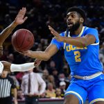 UCLA forward Cody Riley (2) is defended by Arizona State guard DJ Horne (0) during the first half of an NCAA college basketball game Saturday, Feb. 5, 2022, in Tempe, Ariz. (AP Photo/Ross D. Franklin)