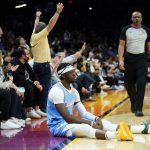 Los Angeles Clippers guard Reggie Jackson sits on the court after committing a foul against the Phoenix Suns during the first half of an NBA basketball game Tuesday, Feb. 15, 2022, in Phoenix. (AP Photo/Matt York)