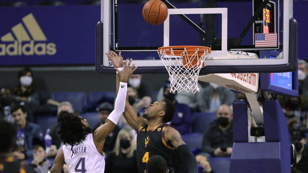 Arizona State's Kimani Lawrence tips the ball in for a basket as Washington's PJ Fuller defends dur...