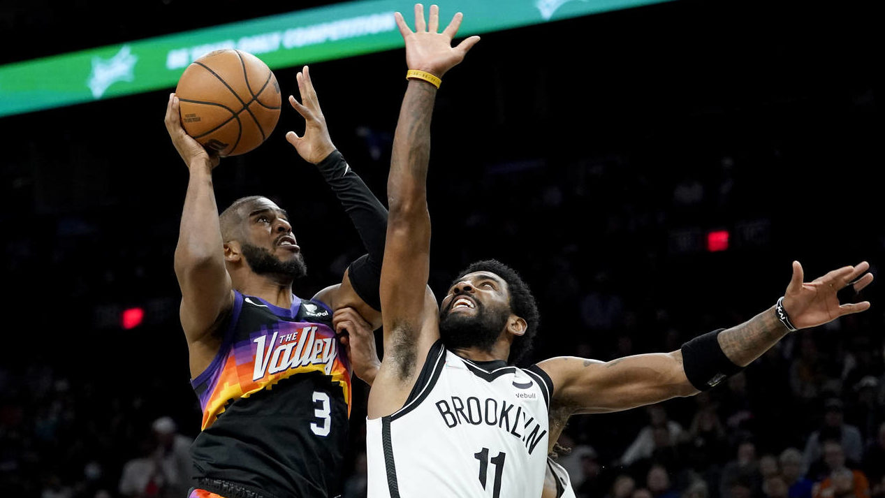 Phoenix Suns guard Chris Paul (3) drives as Brooklyn Nets guard Kyrie Irving (11) defends during th...