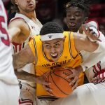 Utah's Rollie Worster, left, and Lahat Thioune, right, defend against Arizona State forward Jalen Graham, center, during the first half of an NCAA college basketball game Saturday, Feb. 26, 2022, in Salt Lake City. (AP Photo/Rick Bowmer)