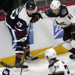 Colorado Avalanche right wing Logan O'Connor, left, vies for control of the puck with Arizona Coyotes defenseman Dysin Mayo during the first period of an NHL hockey game Tuesday, Feb. 1, 2022, in Denver. (AP Photo/David Zalubowski)