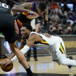 Utah Jazz guard Donovan Mitchell is fouled by Phoenix Suns forward Torrey Craig, center, as center JaVale McGee (00) defends during the first half of an NBA basketball game, Sunday, Feb. 27, 2022, in Phoenix. (AP Photo/Matt York)