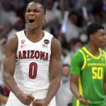 
              Arizona guard Bennedict Mathurin (0) reacts after scoring against Oregon during the first half of an NCAA college basketball game, Saturday, Feb. 19, 2022, in Tucson, Ariz. (AP Photo/Rick Scuteri)
            