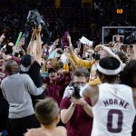 Arizona State players and fans celebrate after Arizona State defeated UCLA 87-84 in three overtimes in an NCAA college basketball game Saturday, Feb. 5, 2022, in Tempe, Ariz. (AP Photo/Ross D. Franklin)