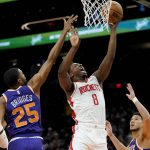 
              Houston Rockets forward Jae'Sean Tate (8) shoots as Phoenix Suns forward Mikal Bridges (25) defends during the first half of an NBA basketball game Wednesday, Feb. 16, 2022, in Phoenix. (AP Photo/Matt York)
            