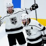 Los Angeles Kings defenseman Drew Doughty (8) shouts as he celebrates his third-period goal against the Arizona Coyotes with center Adrian Kempe (9) during an NHL hockey game Saturday, Feb. 19, 2022, in Glendale, Ariz. (AP Photo/Ross D. Franklin)
