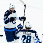 Winnipeg Jets center Adam Lowry (17) celebrates his goal against the Arizona Coyotes with Jets defenseman Nathan Beaulieu (28) during the first period of an NHL hockey game Sunday, Feb. 27, 2022, in Glendale, Ariz. (AP Photo/Ross D. Franklin)
