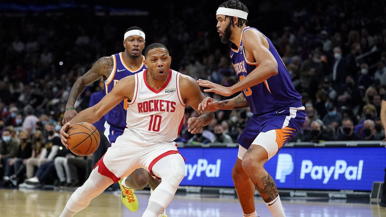 Houston Rockets guard Eric Gordon (10) drives against Phoenix Suns center JaVale McGee during the f...