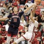 Arizona forward Azuolas Tubelis (10) knocks the ball away from Washington State guard Michael Flowers (12) during the first half of an NCAA college basketball game, Thursday, Feb. 10, 2022, in Pullman, Wash. (AP Photo/Geoff Crimmins)
