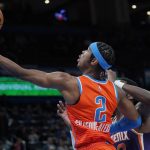 Oklahoma City Thunder guard Shai Gilgeous-Alexander (2) goes to the basket past Phoenix Suns center Deandre Ayton, right, in the first half of an NBA basketball game Thursday, Feb. 24, 2022, in Oklahoma City. (AP Photo/Sue Ogrocki)