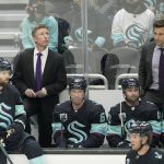 Seattle Kraken coach Dave Hakstol, left, and assistant coach Jay Leach stand behind the bench during the second period of the team's NHL hockey game against the Arizona Coyotes, Wednesday, Feb. 9, 2022, in Seattle. (AP Photo/Ted S. Warren)