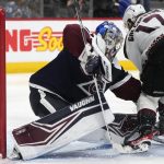 Colorado Avalanche goaltender Darcy Kuemper, left, stops a shot by Arizona Coyotes center Alex Galchenyuk during the second period of an NHL hockey game Tuesday, Feb. 1, 2022, in Denver. (AP Photo/David Zalubowski)