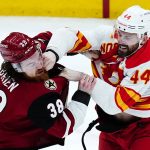 
              Calgary Flames defenseman Erik Gudbranson (44) connects with a punch as he fights Arizona Coyotes center Liam O'Brien (38) during the first period of an NHL hockey game Wednesday, Feb. 2, 2022, in Glendale, Ariz. (AP Photo/Ross D. Franklin)
            